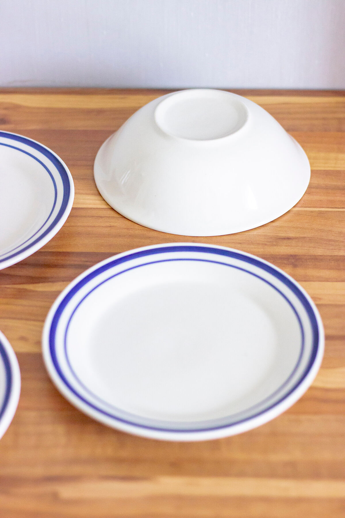 4 blue bordered dessert plates and a matching bowl