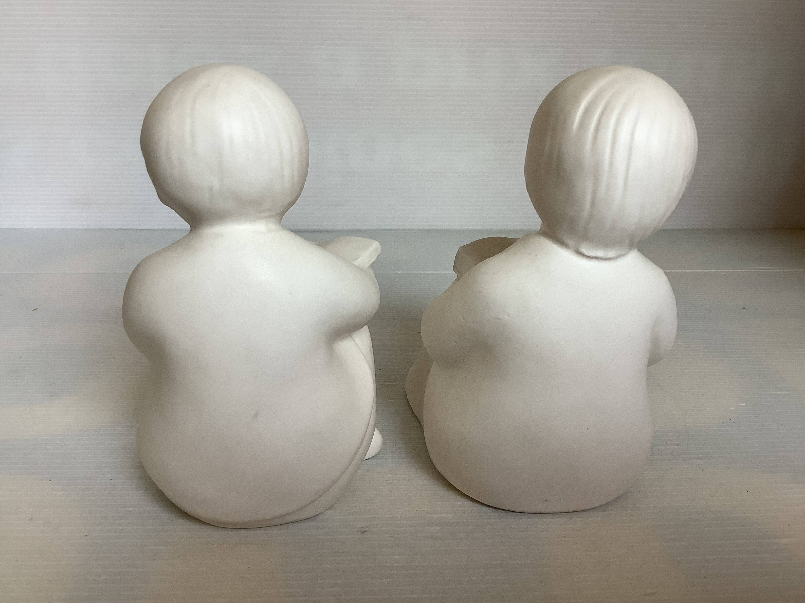 Pair of bookends with a matte white glaze for children.