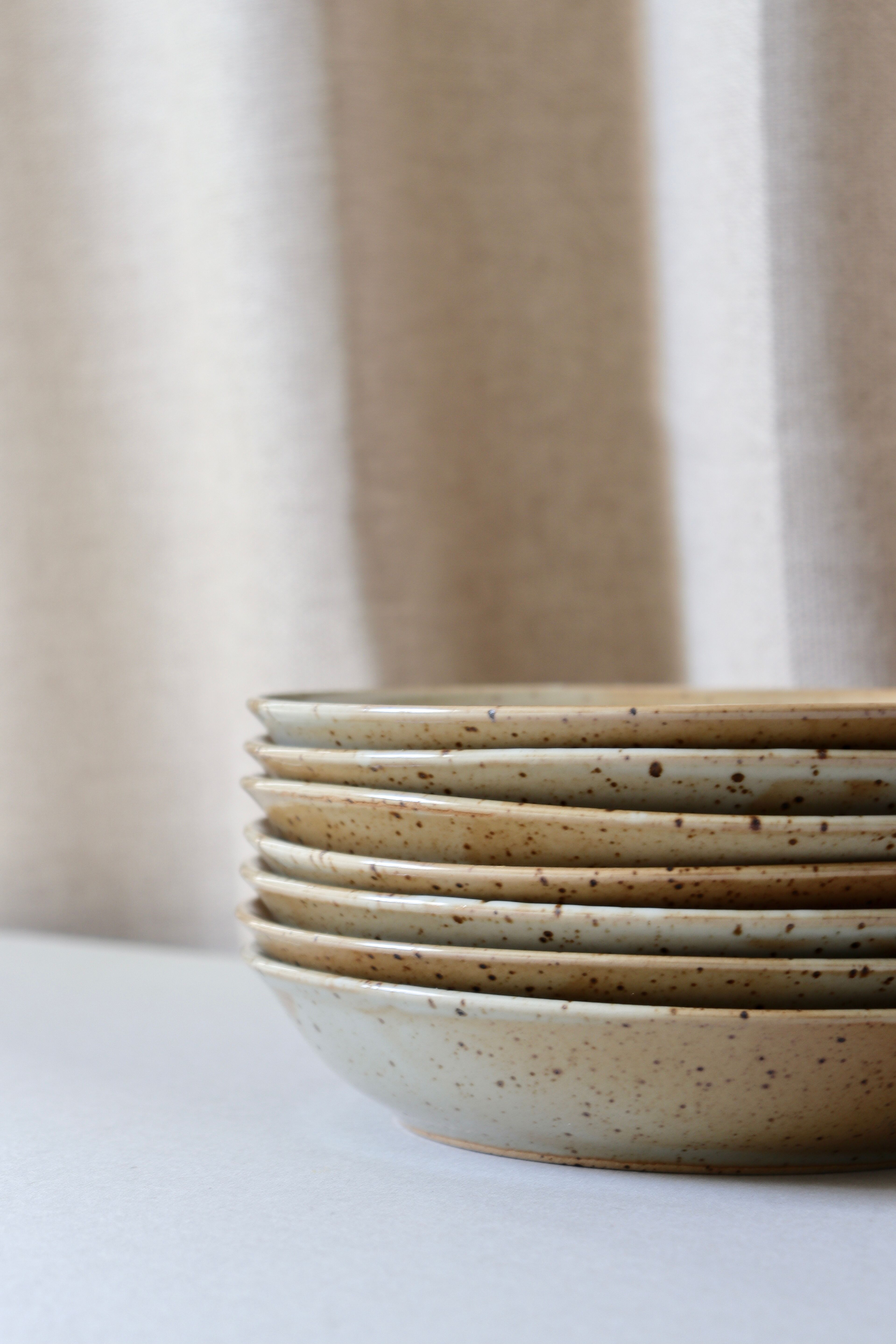 7 speckled stoneware plates