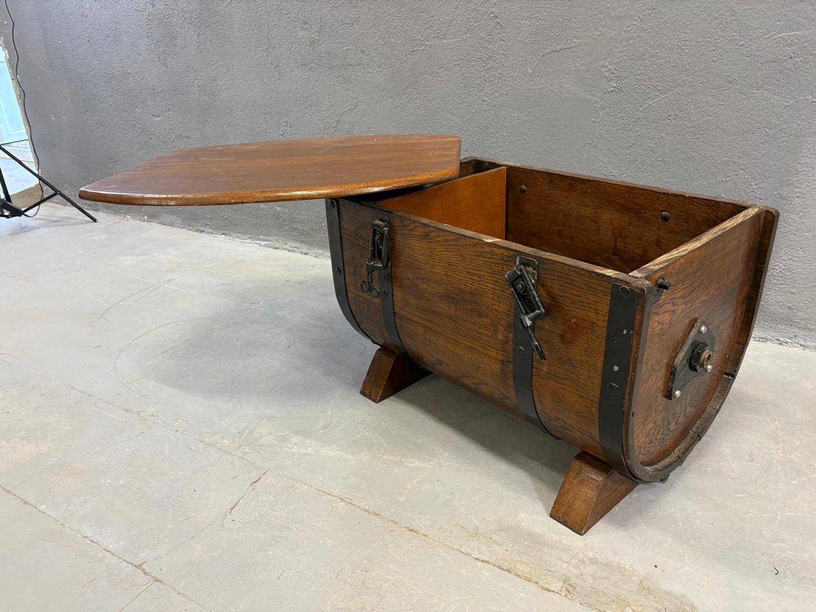 Oak barrel-shaped storage chest with black metal straps, 1930s-1940s.