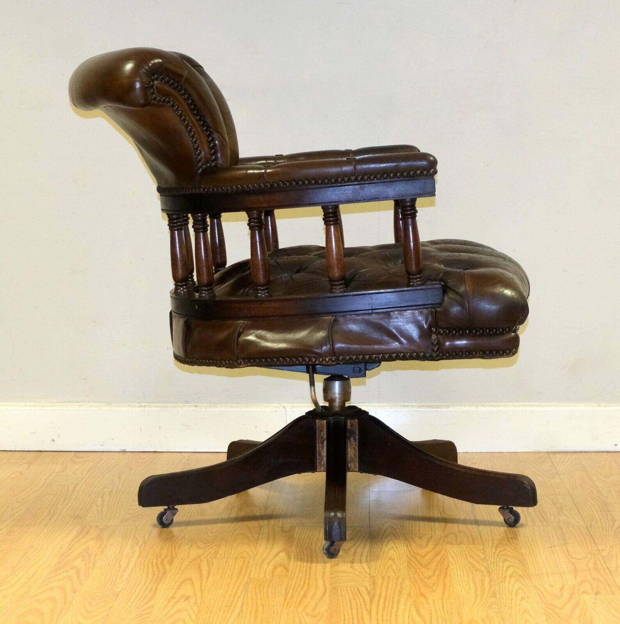 Restored Chesterfield captain's armchair in leather with an oak frame.