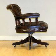 Restored Chesterfield captain's armchair in leather with an oak frame.