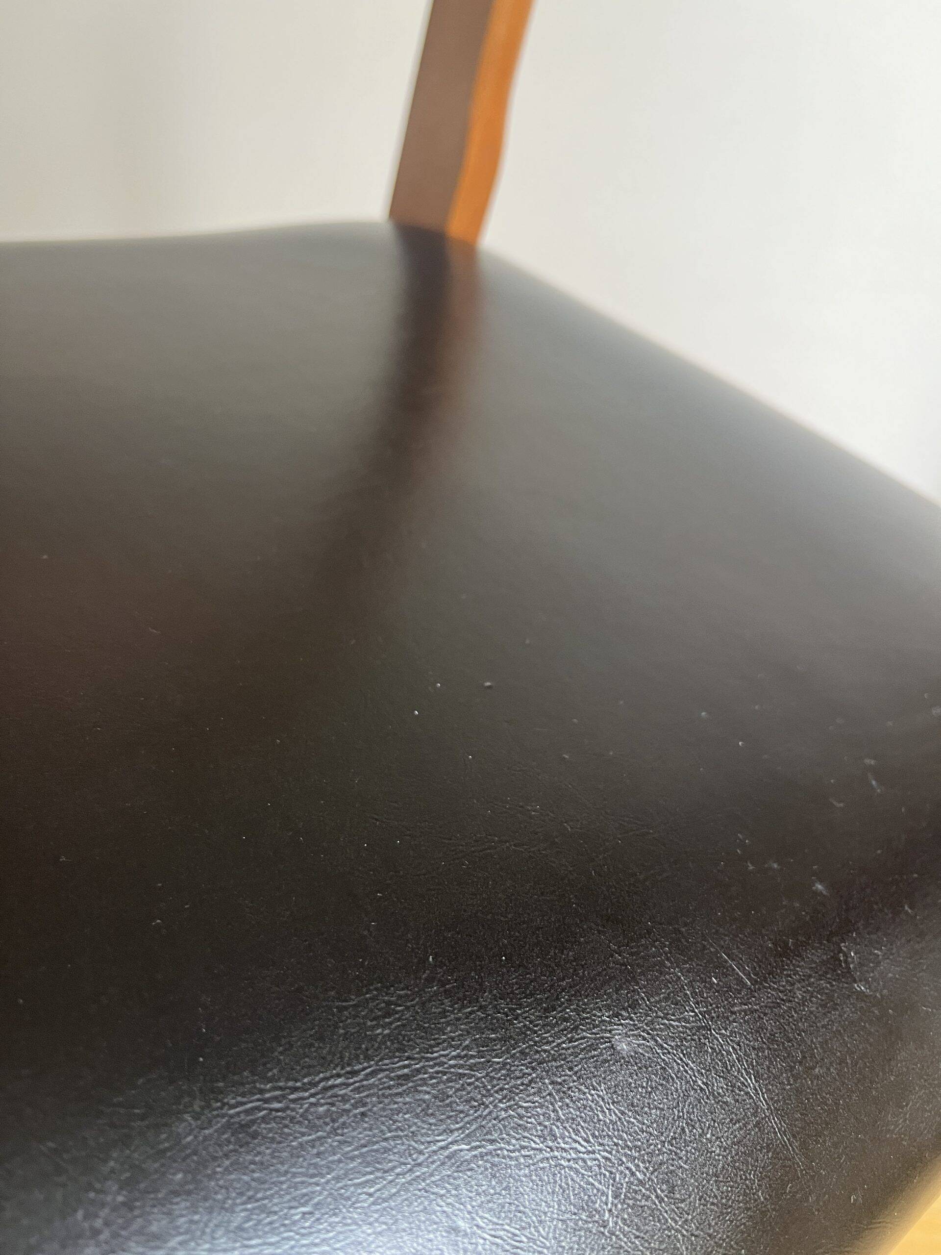 Vintage chair in wood and black leatherette