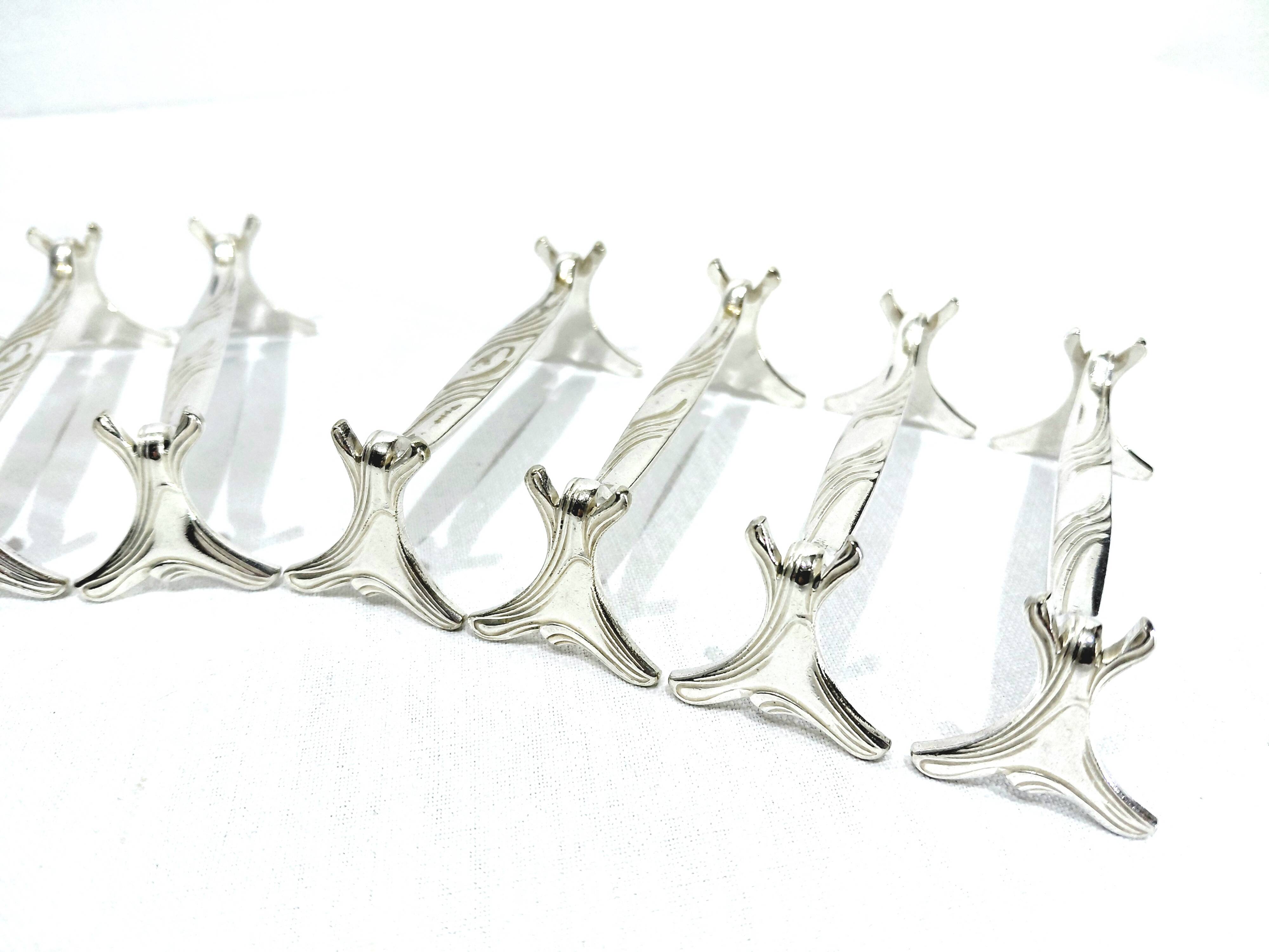 CHRISTOFLE - SET OF 11 SILVER-PLATED KNIFE RESTS