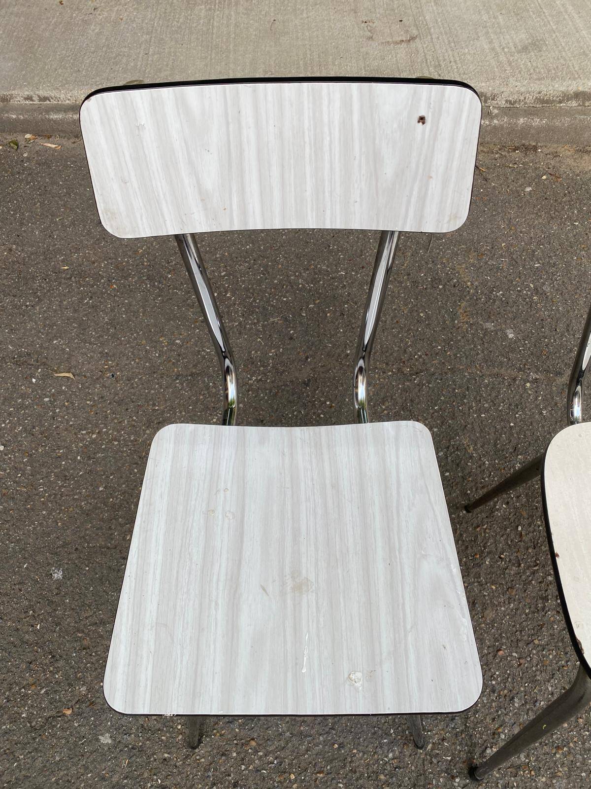 2 beige formica and steel chairs