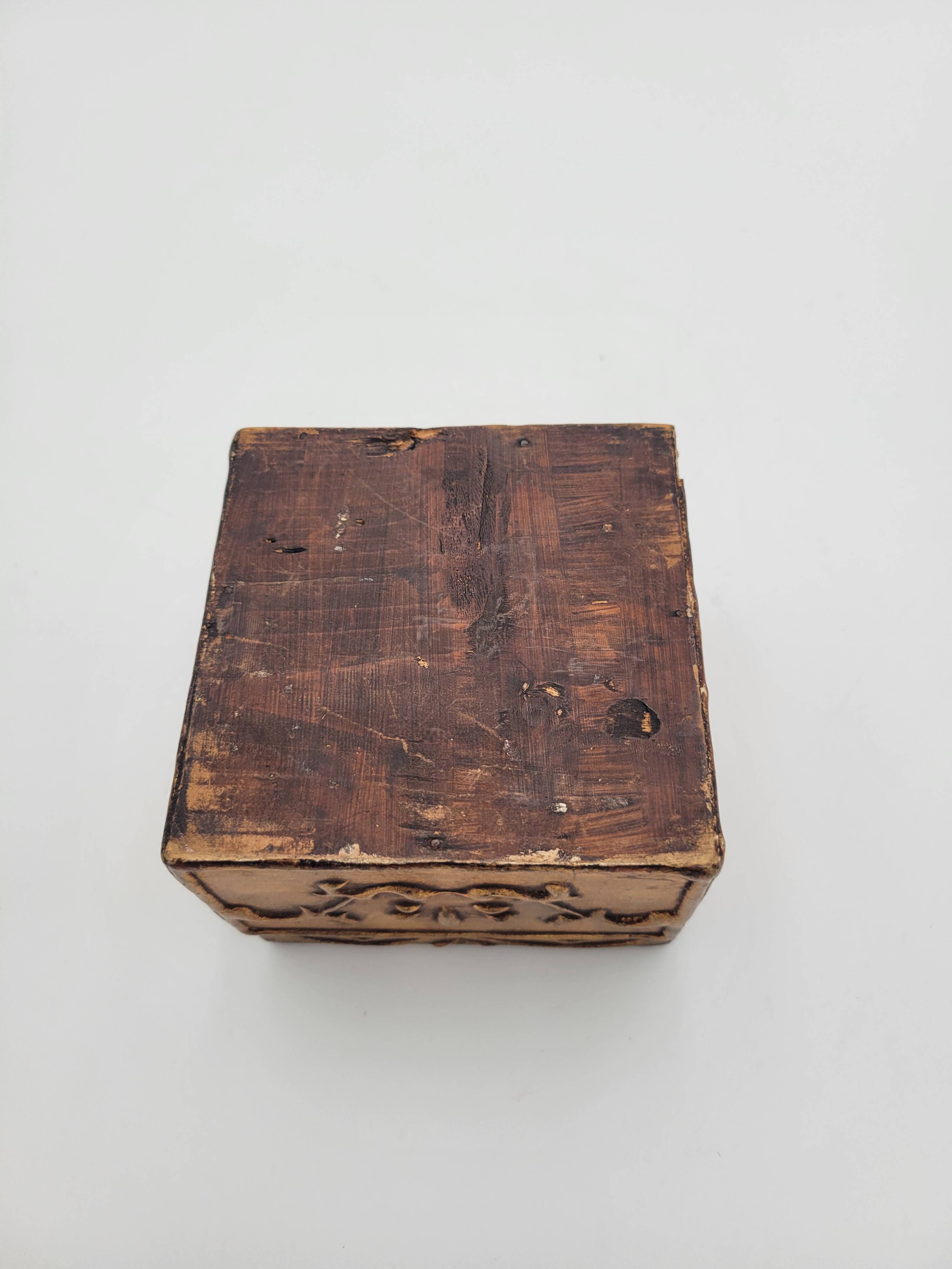 Old jewelry box in wood and gilded stucco