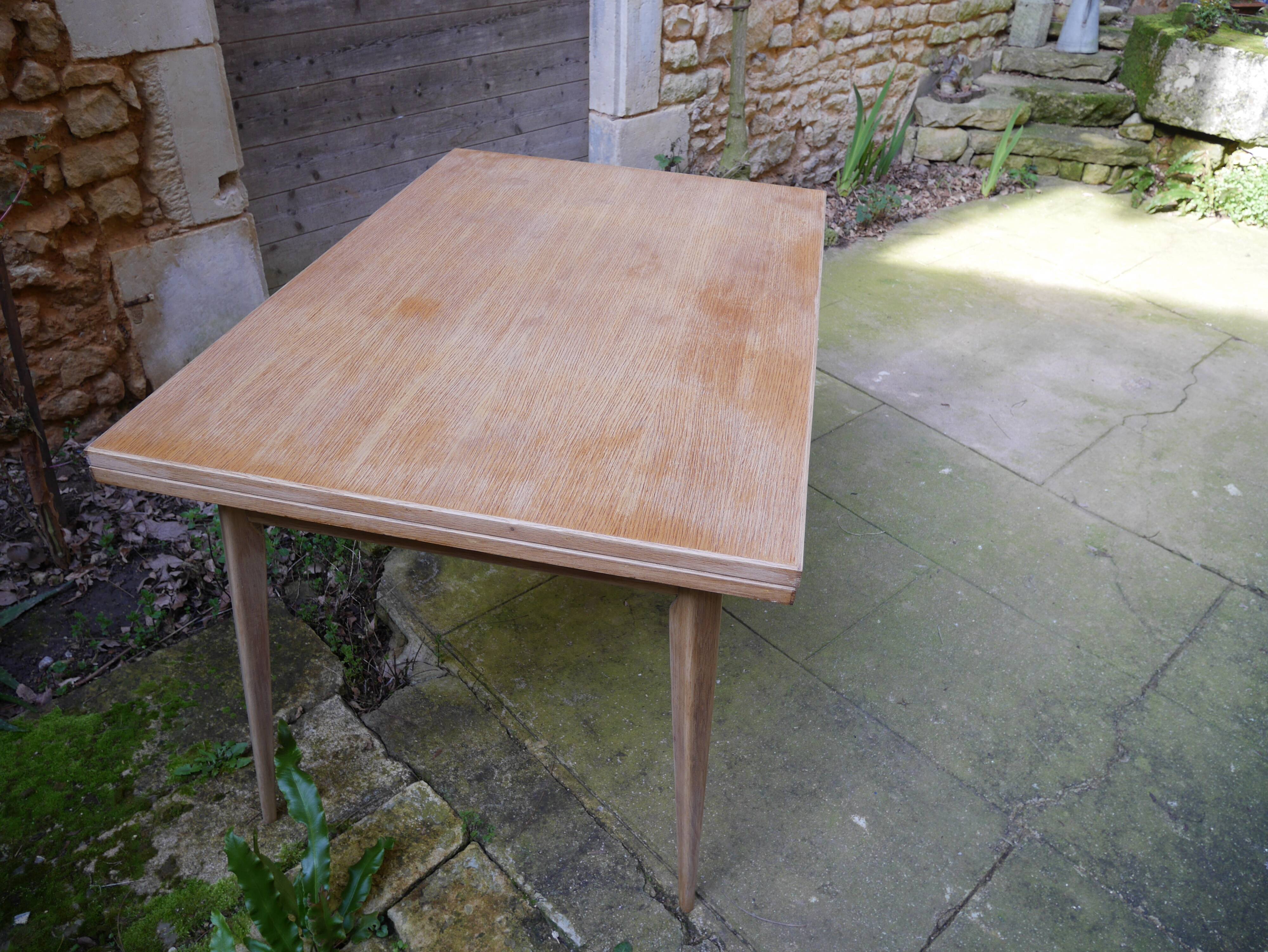 wooden dining table with compass legs and extensions