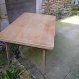 wooden dining table with compass legs and extensions