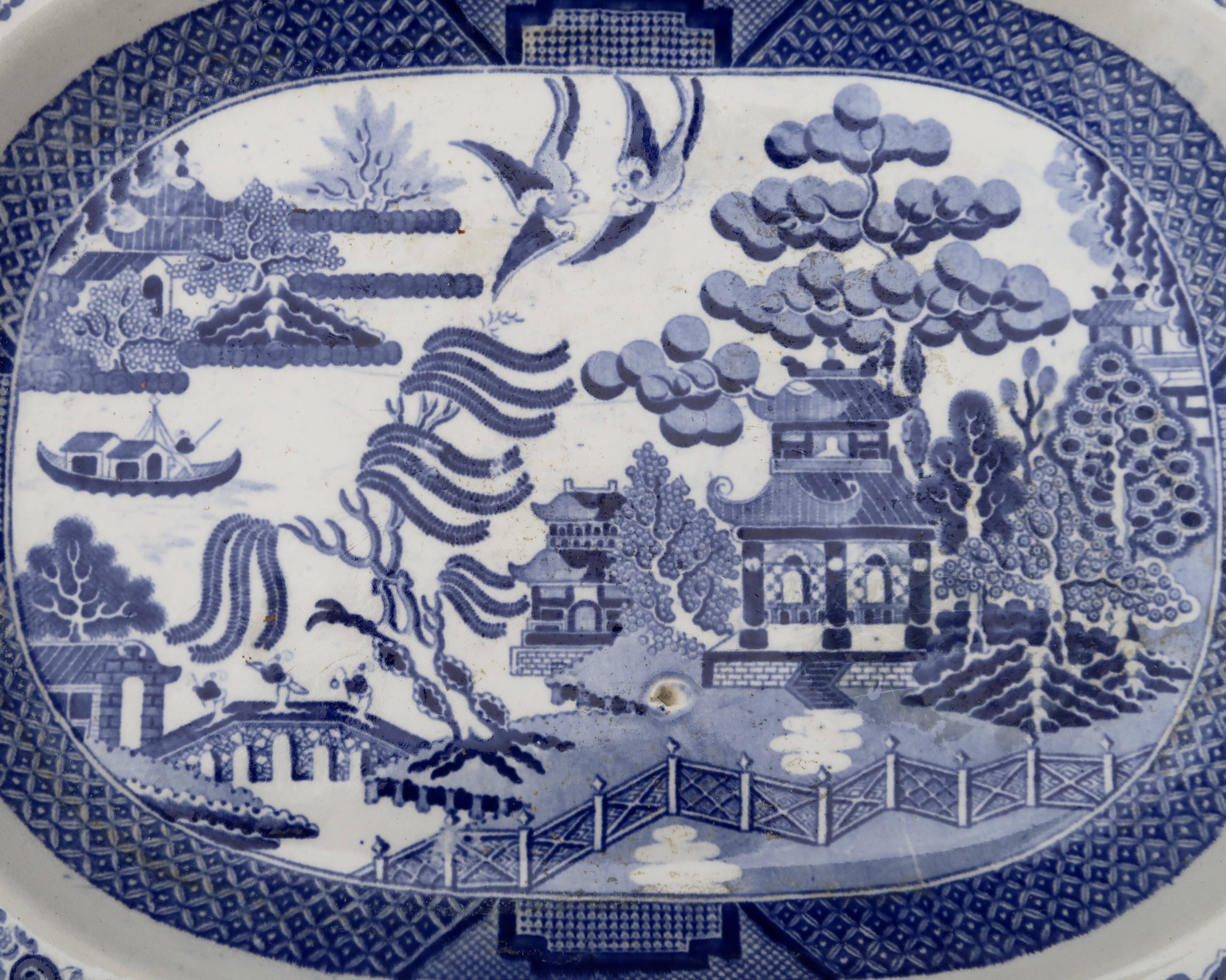 Large oval dish in blue and white English earthenware with Asian decoration, 19th century.