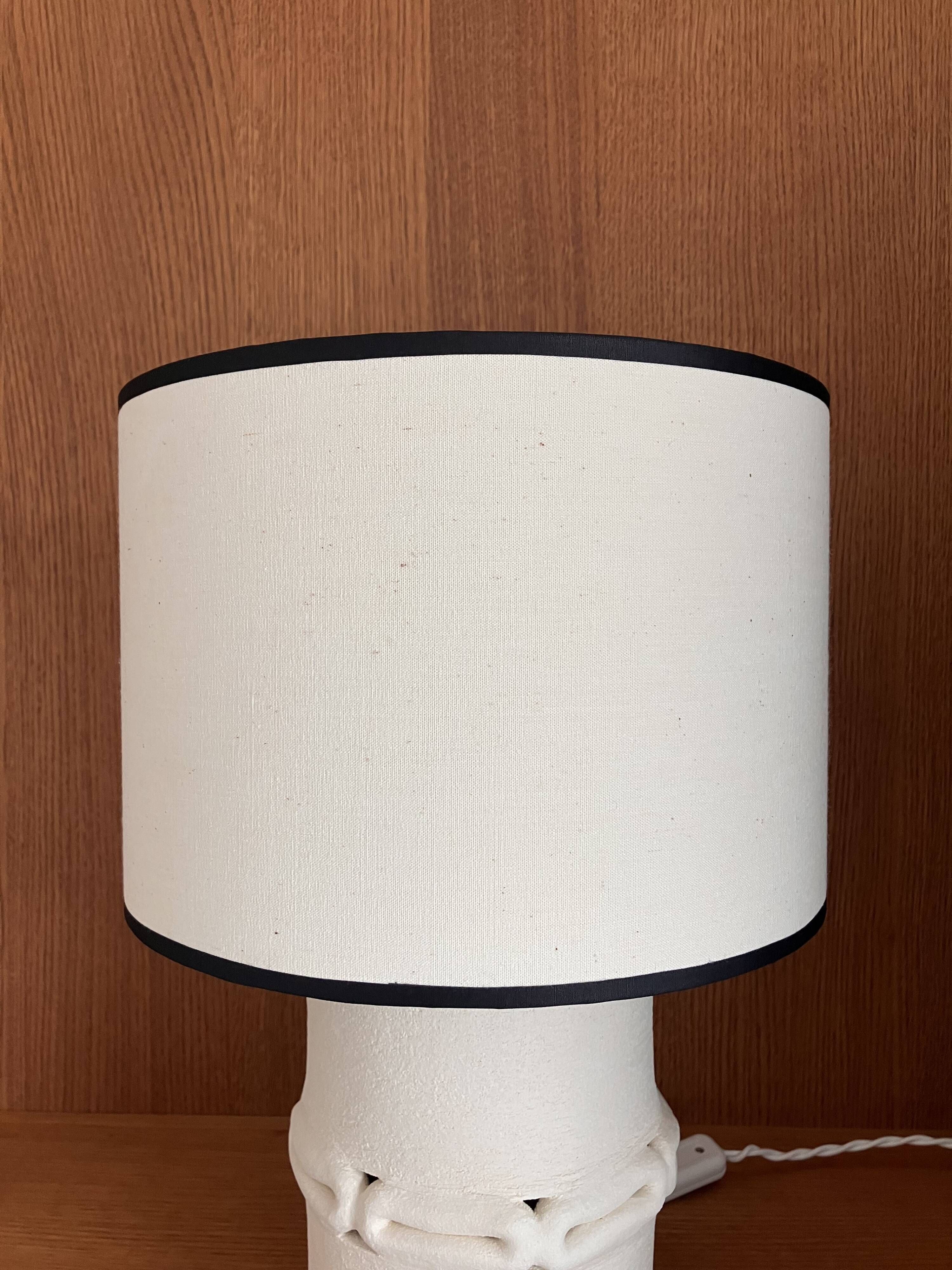 Table lamp in ceramic with a handmade couture-style lampshade from France.