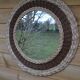 Round woven rattan mirror with rope from the 1970s.