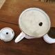 Enamelled sheet metal coffee maker with floral decoration