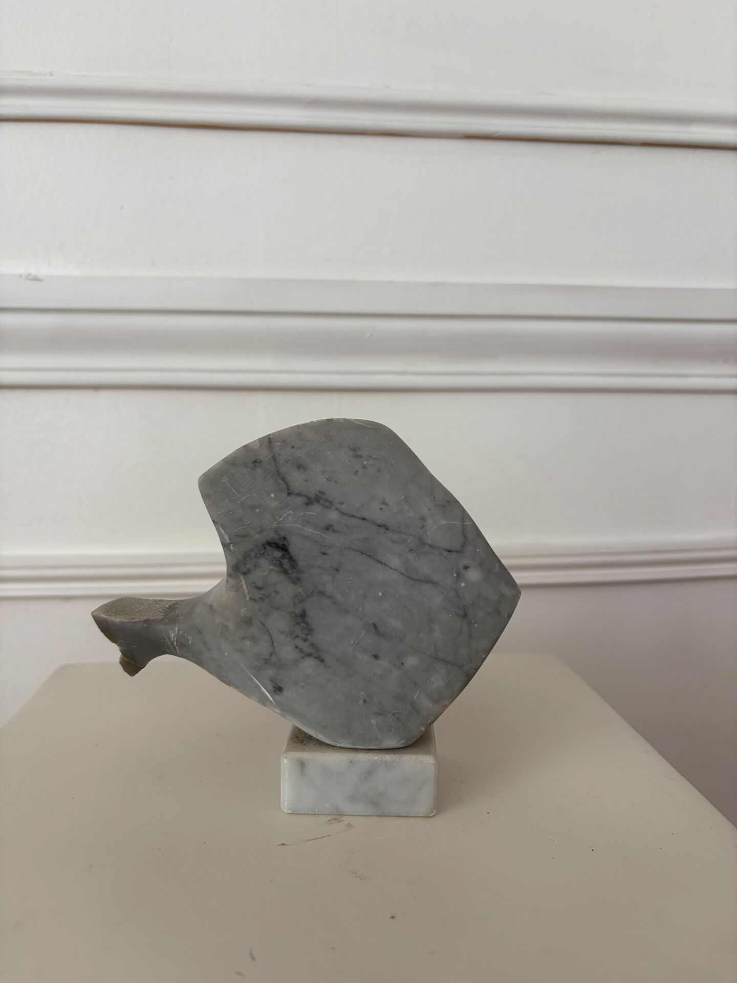 Marble sculpture in the shape of a fish.