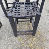 5 blackened wooden stools with woven leather seats by Nina Kaufmann