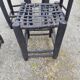 5 blackened wooden stools with woven leather seats by Nina Kaufmann