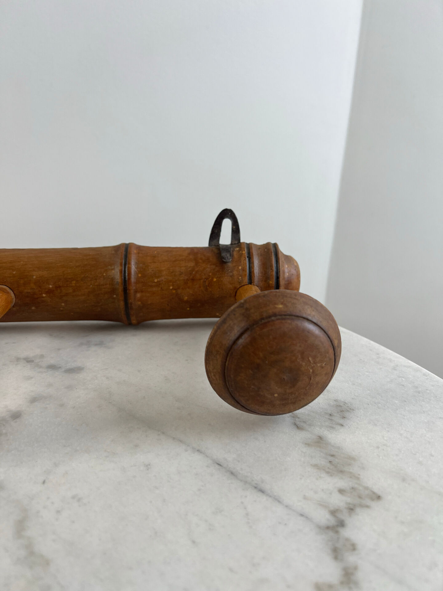 Wooden coat rack with three ball hooks.