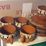 Terracotta service decorated with psychedelic drips