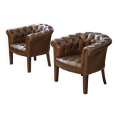 Paire de fauteuils Club capitonnés en cuir