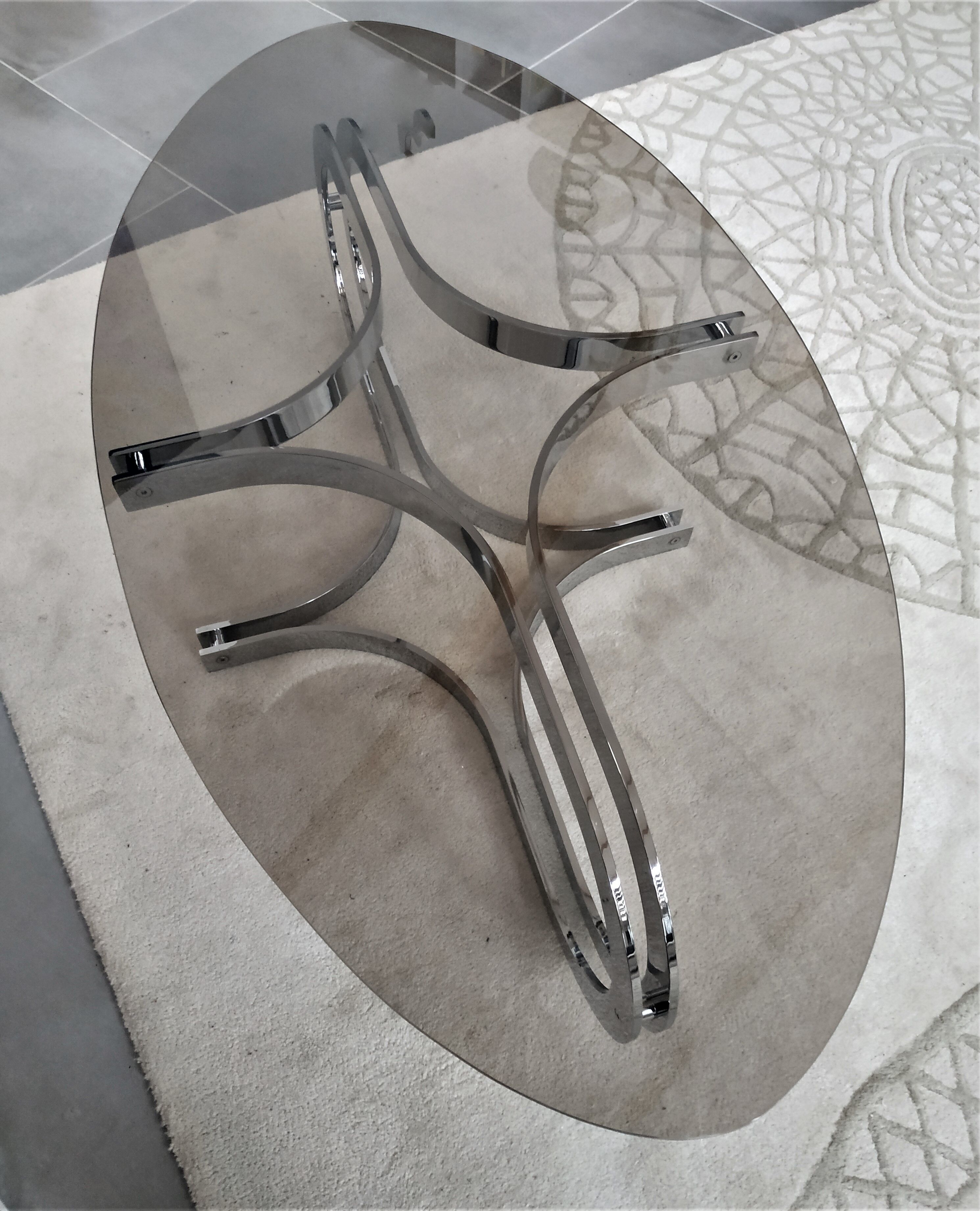 Chrome metal coffee table and oval smoked glass tray