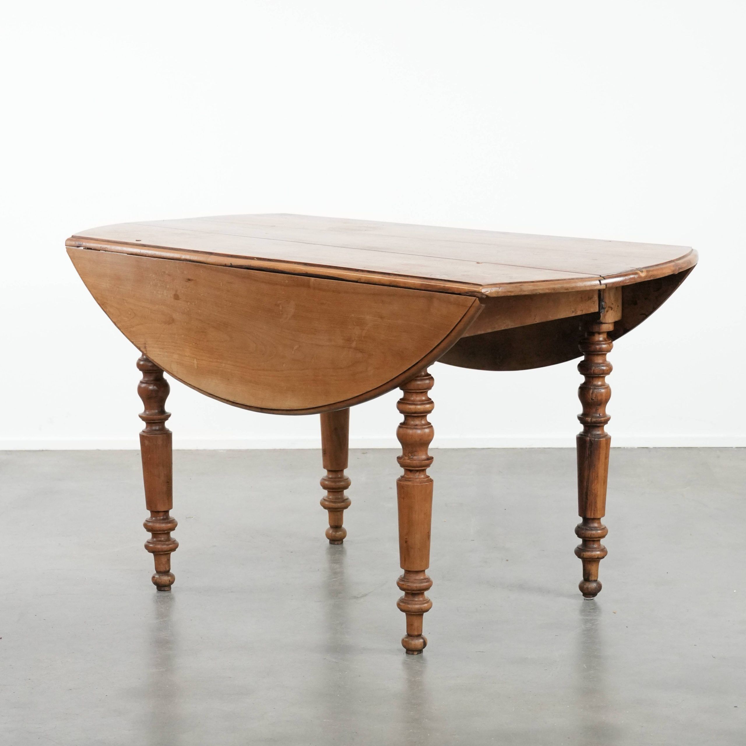Antique English drop-leaf dining table made of walnut with elegant legs