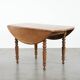 Antique English drop-leaf dining table made of walnut with elegant legs