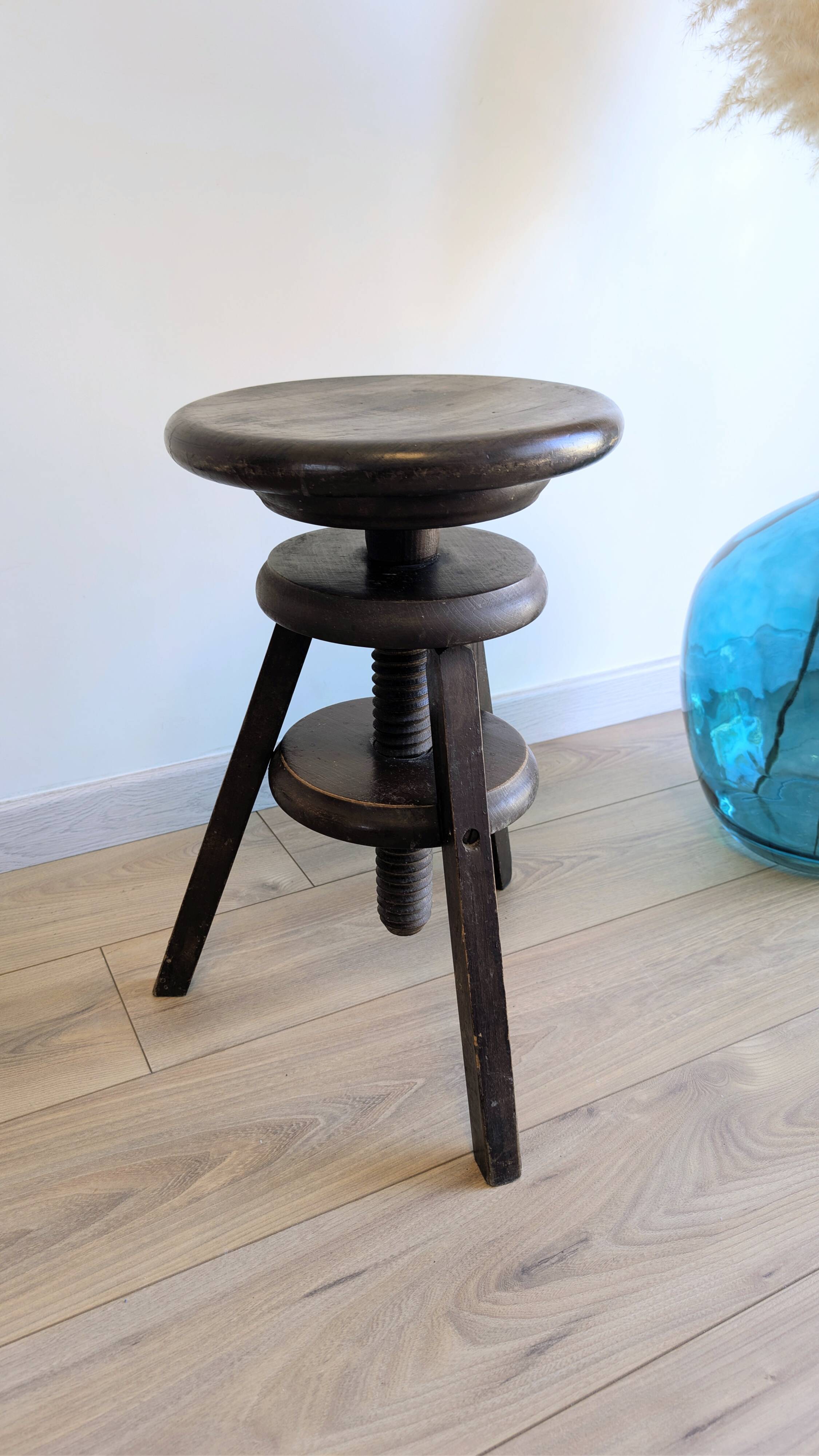 Antique wooden watchmaker's stool with screws, patinated wood.