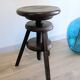 Antique wooden watchmaker's stool with screws, patinated wood.