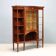 Mahogany display cabinet with maple inlays.