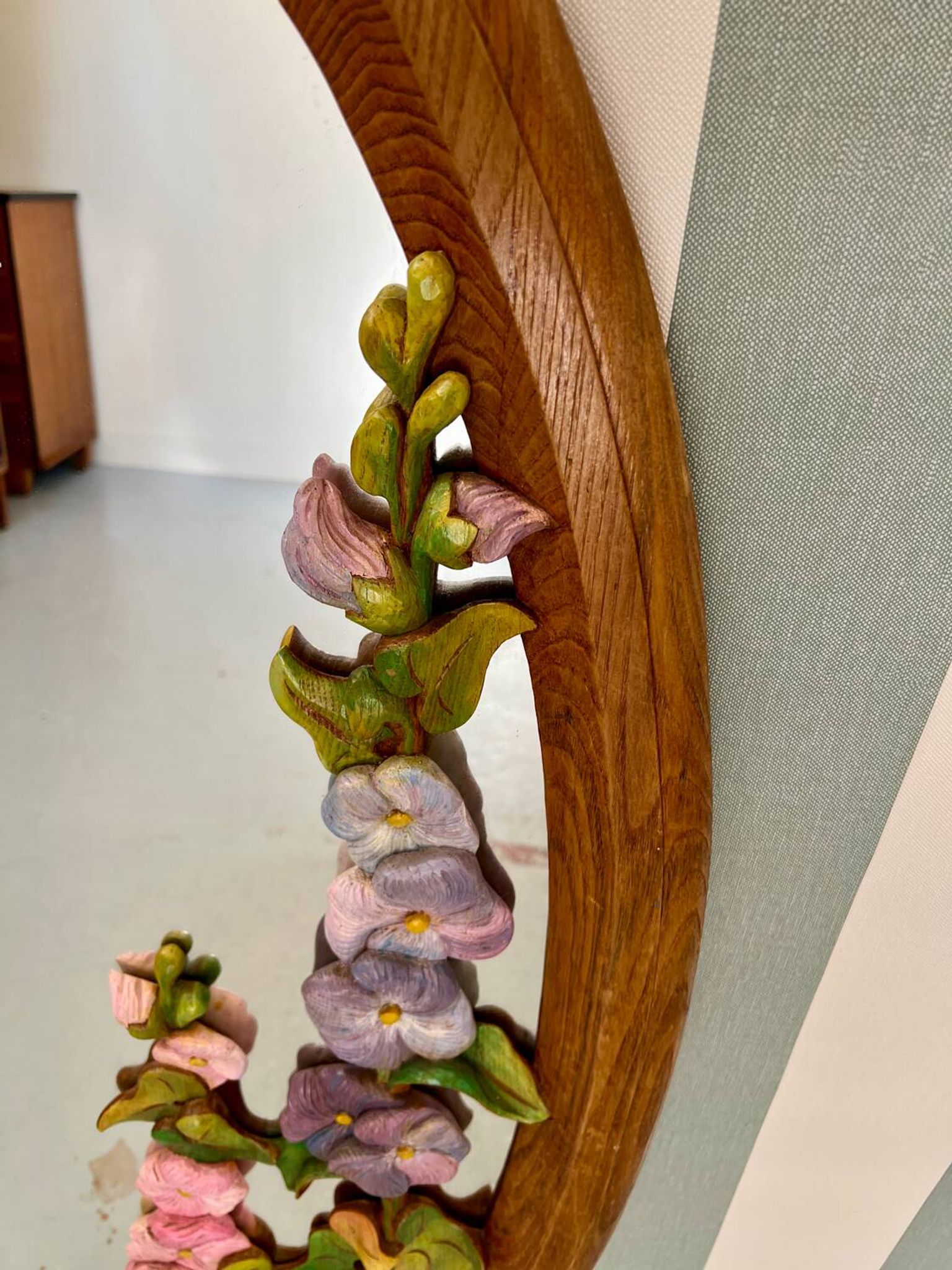 Carved wooden mirror with flower decorations.