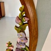 Carved wooden mirror with flower decorations.