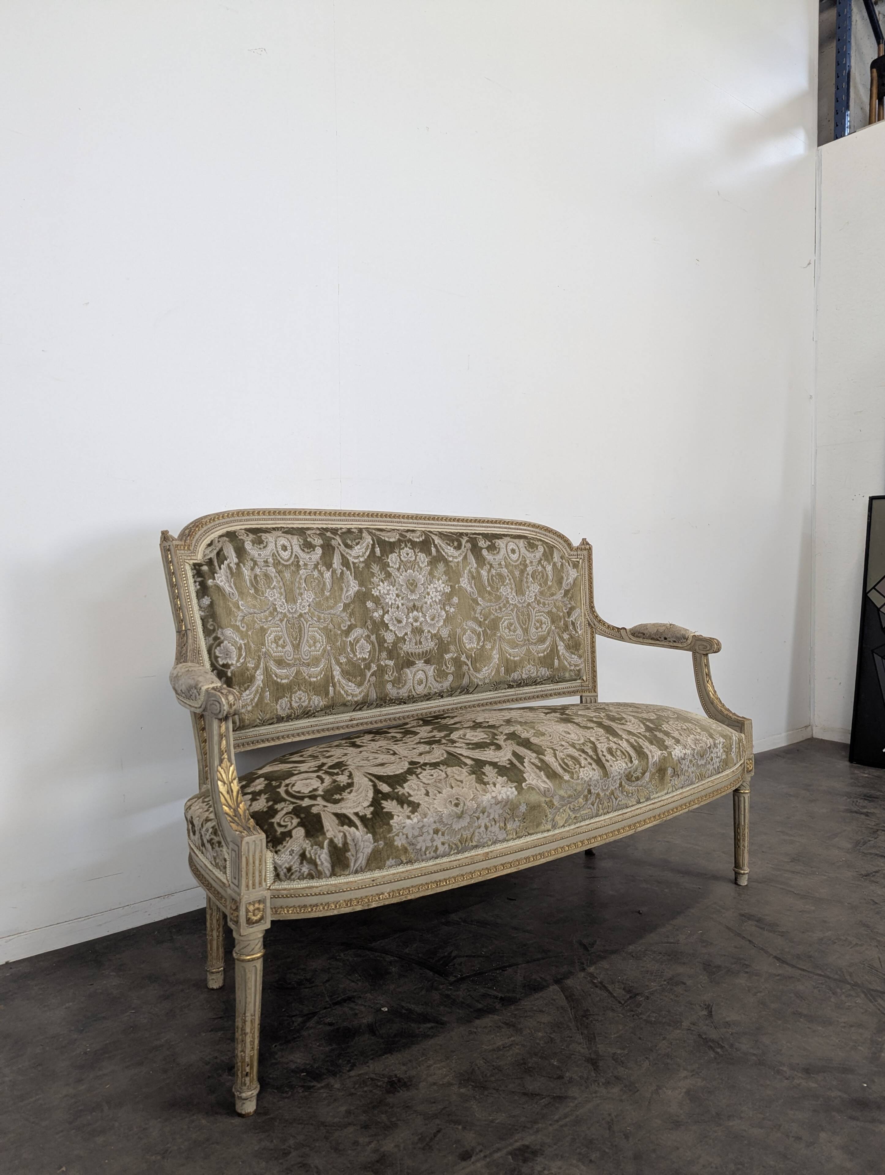 Cream lacquered Louis XVI style cabriolet salon with gold highlights.