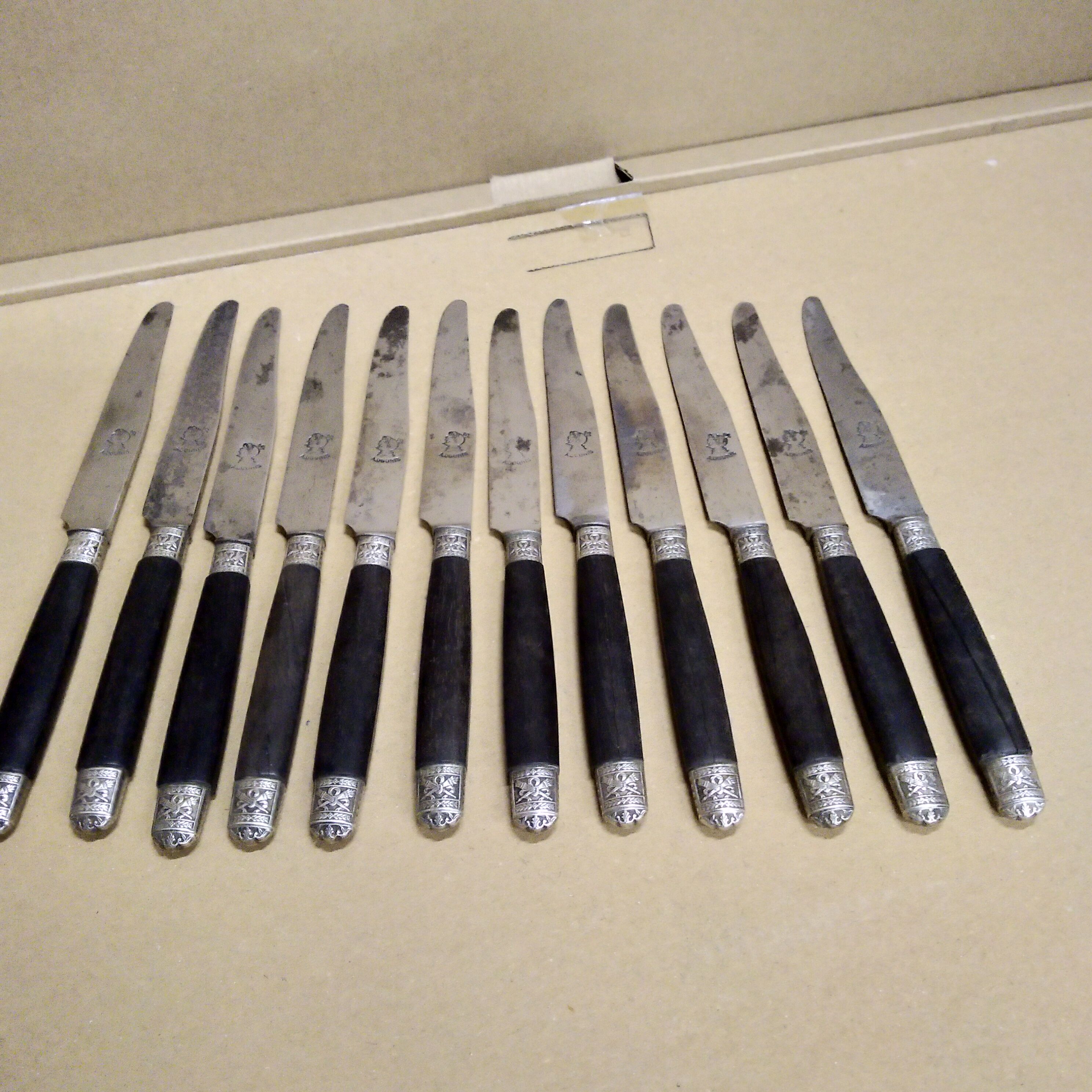 12 Silver dessert knives, ebony, steel, late 19th century