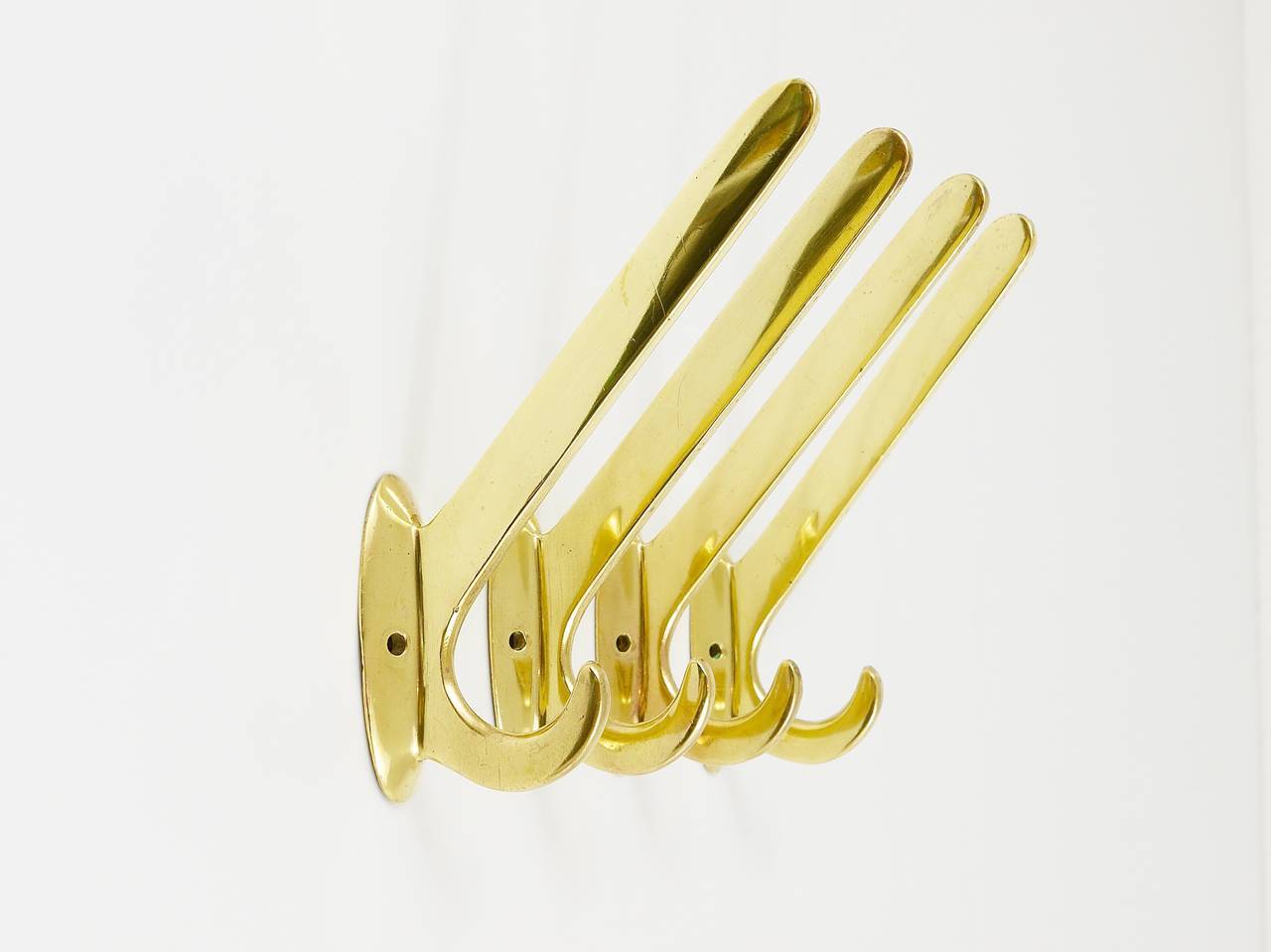 Four handmade brass wall hooks in Art Nouveau style, Austria, 1920s.