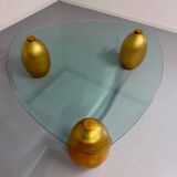 Vintage Italian design coffee table with a glass top and gold base, dating from the 1980s.