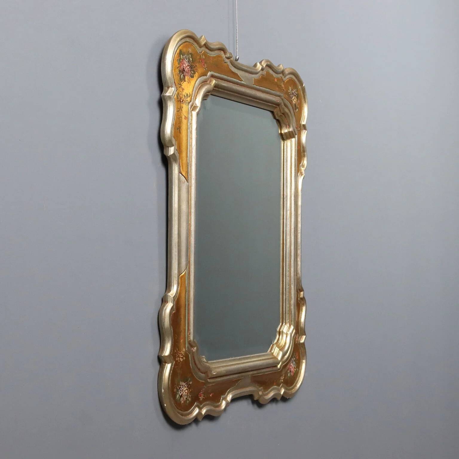 Antique mirror with a gilded frame and floral decorations, Italy, 20th century.