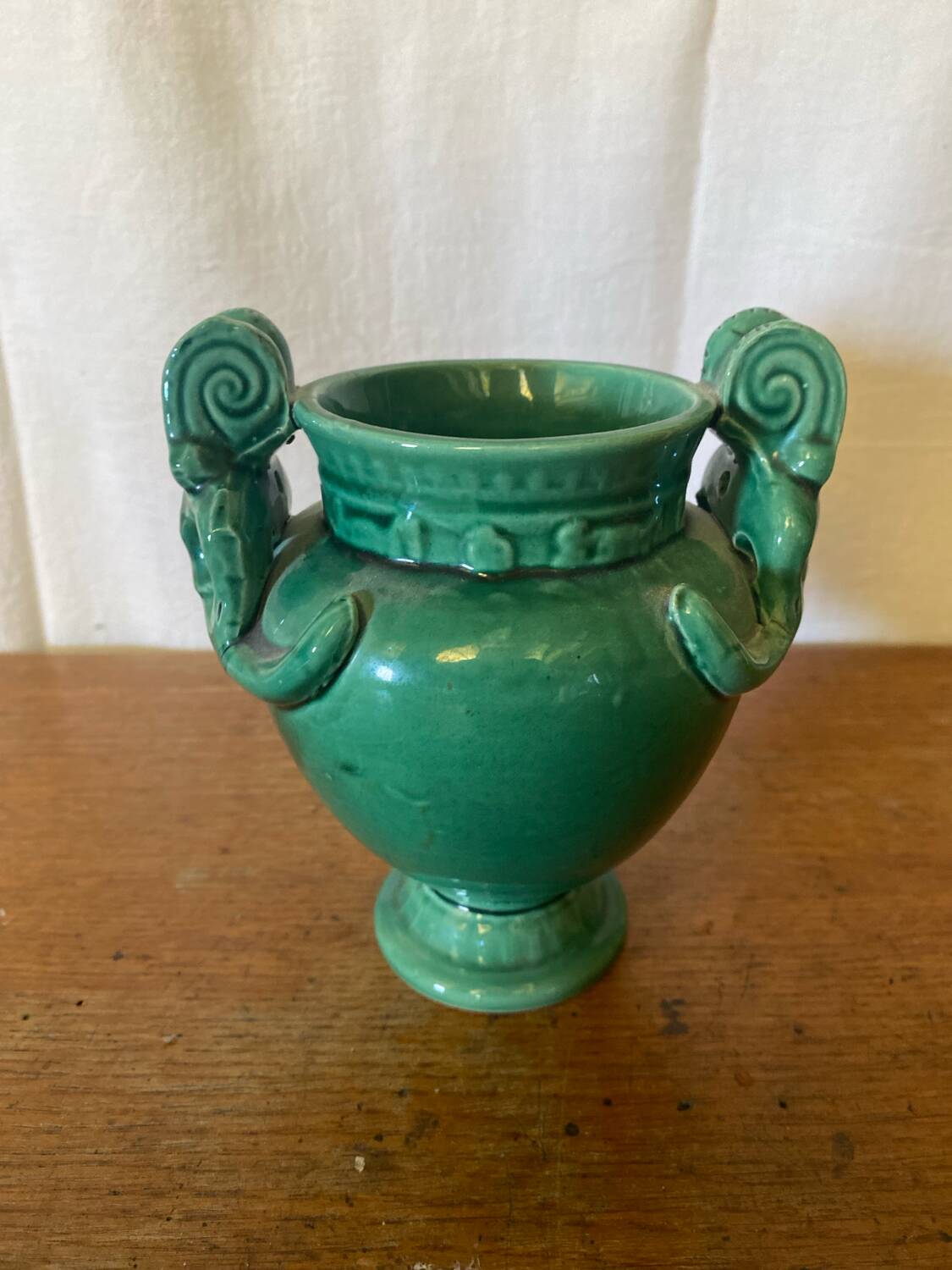 Antique green ceramic vase with handles