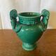 Antique green ceramic vase with handles