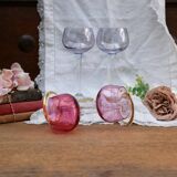 Four colorful stemmed wine glasses