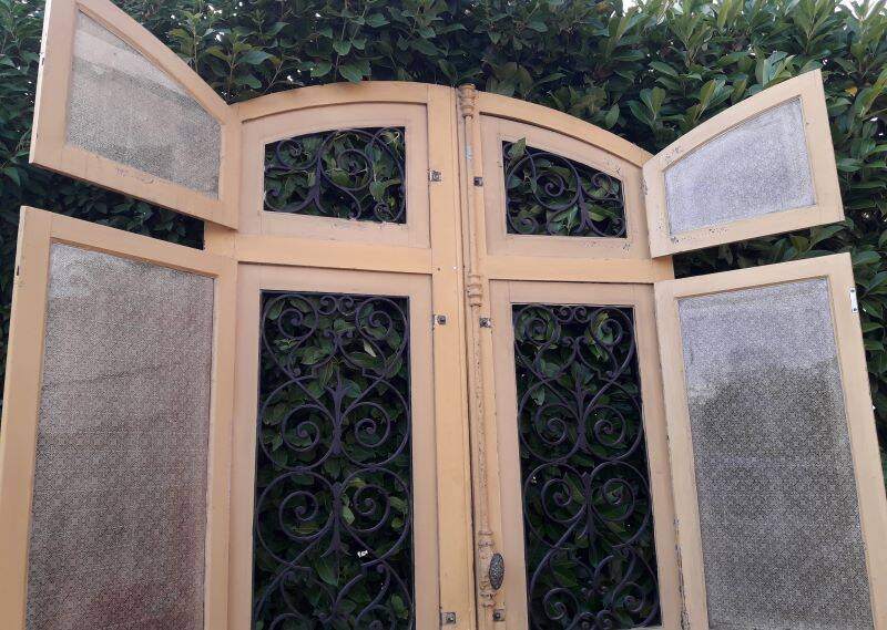 19th century double arched entrance door in oak with grilles and old glass