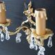 Pair of gilt bronze wall sconces with crystal pendants.