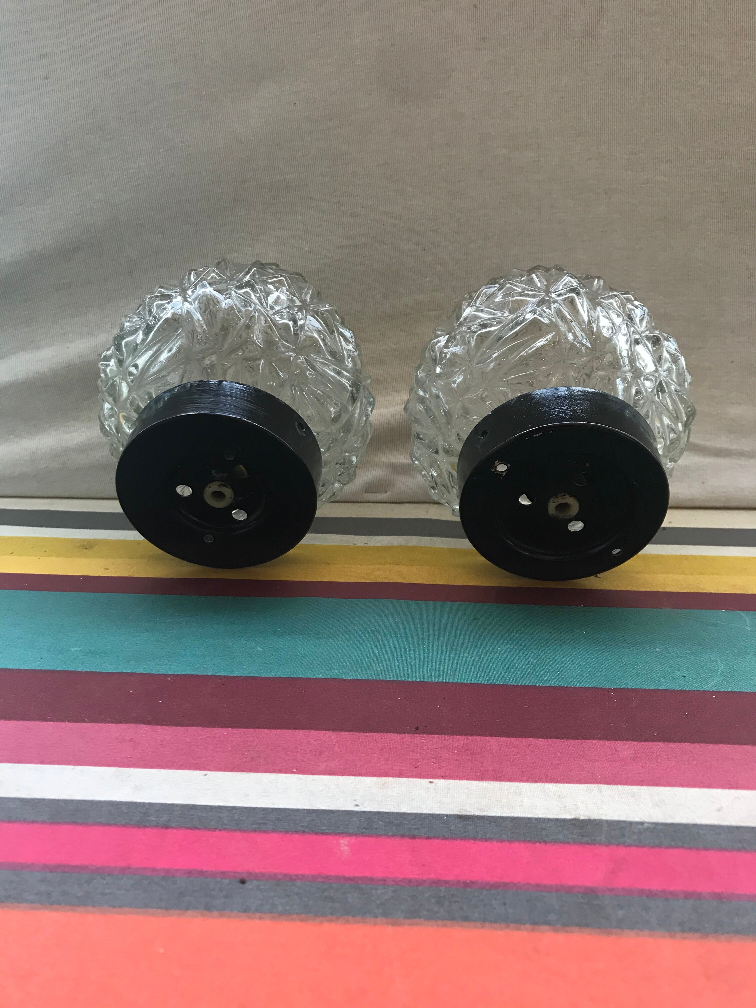 Old pair of glass moulded wall sconces with vintage black metal support