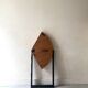 Modernist round folding dining table in wood and metal.