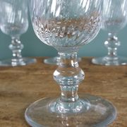 Ancient footed crystal glasses with relief twisted fluted goblets.