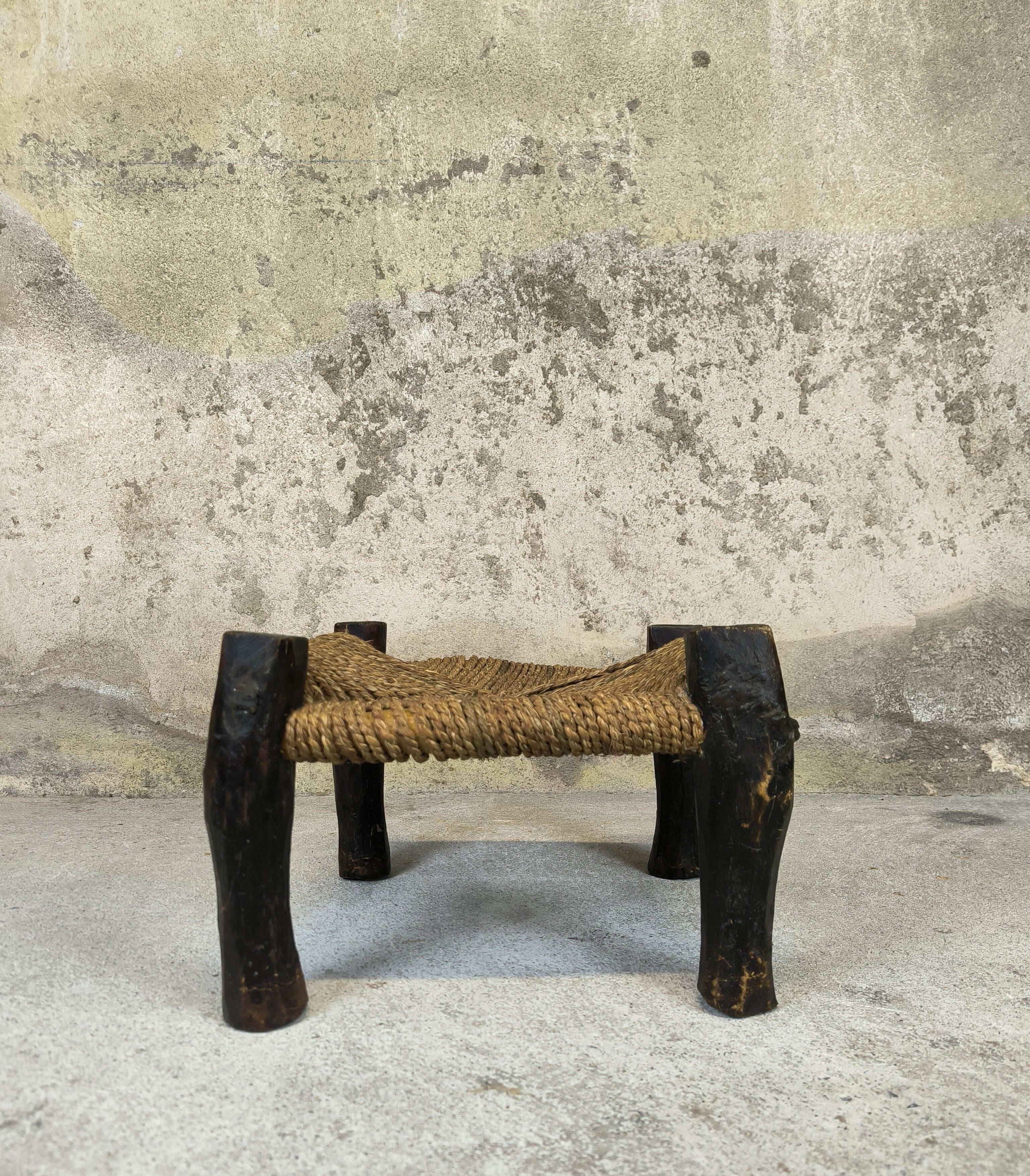 Vintage low stool in wood and straw.