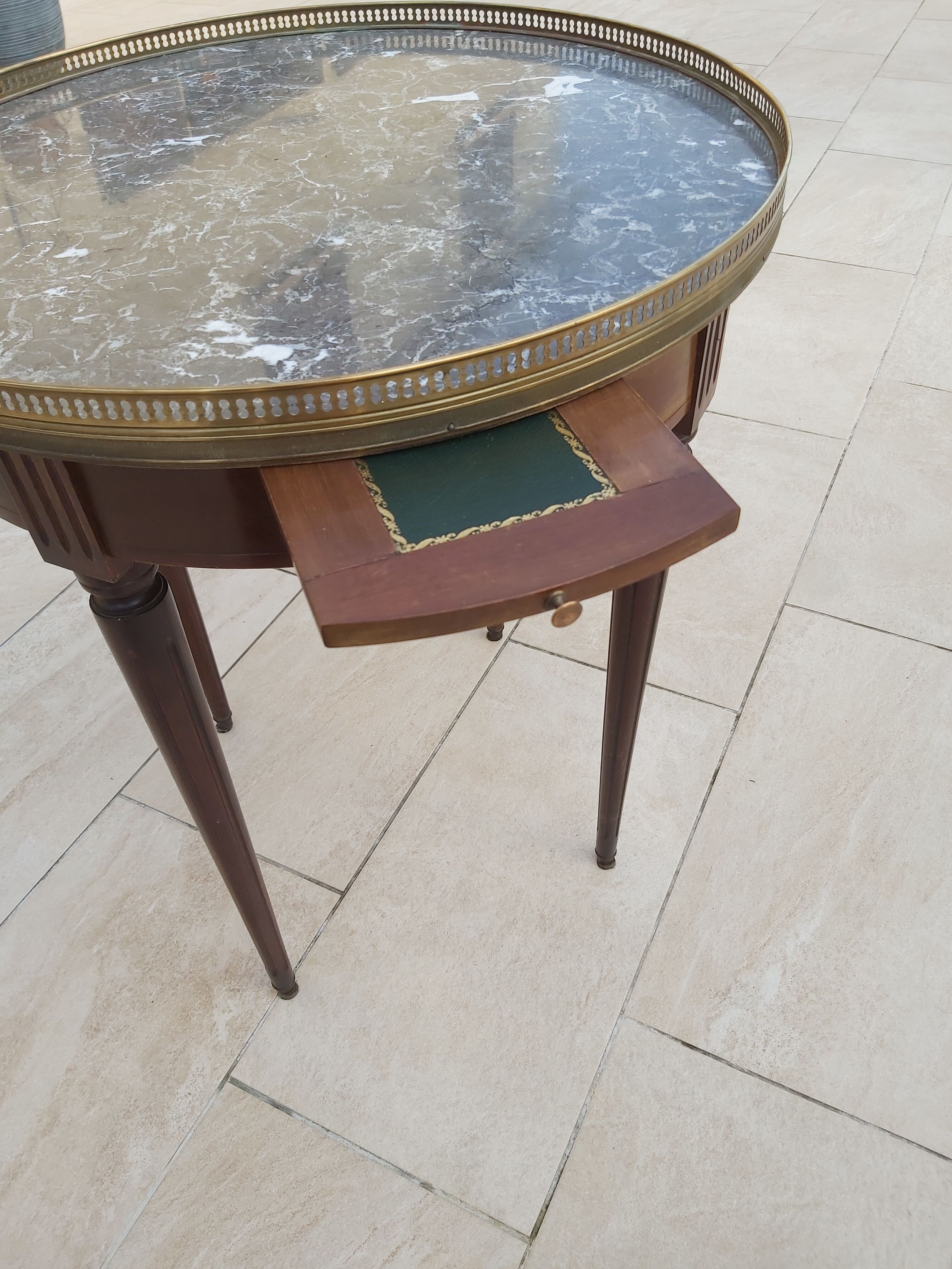 Gray marble mahogany pedestal table and brass gallery