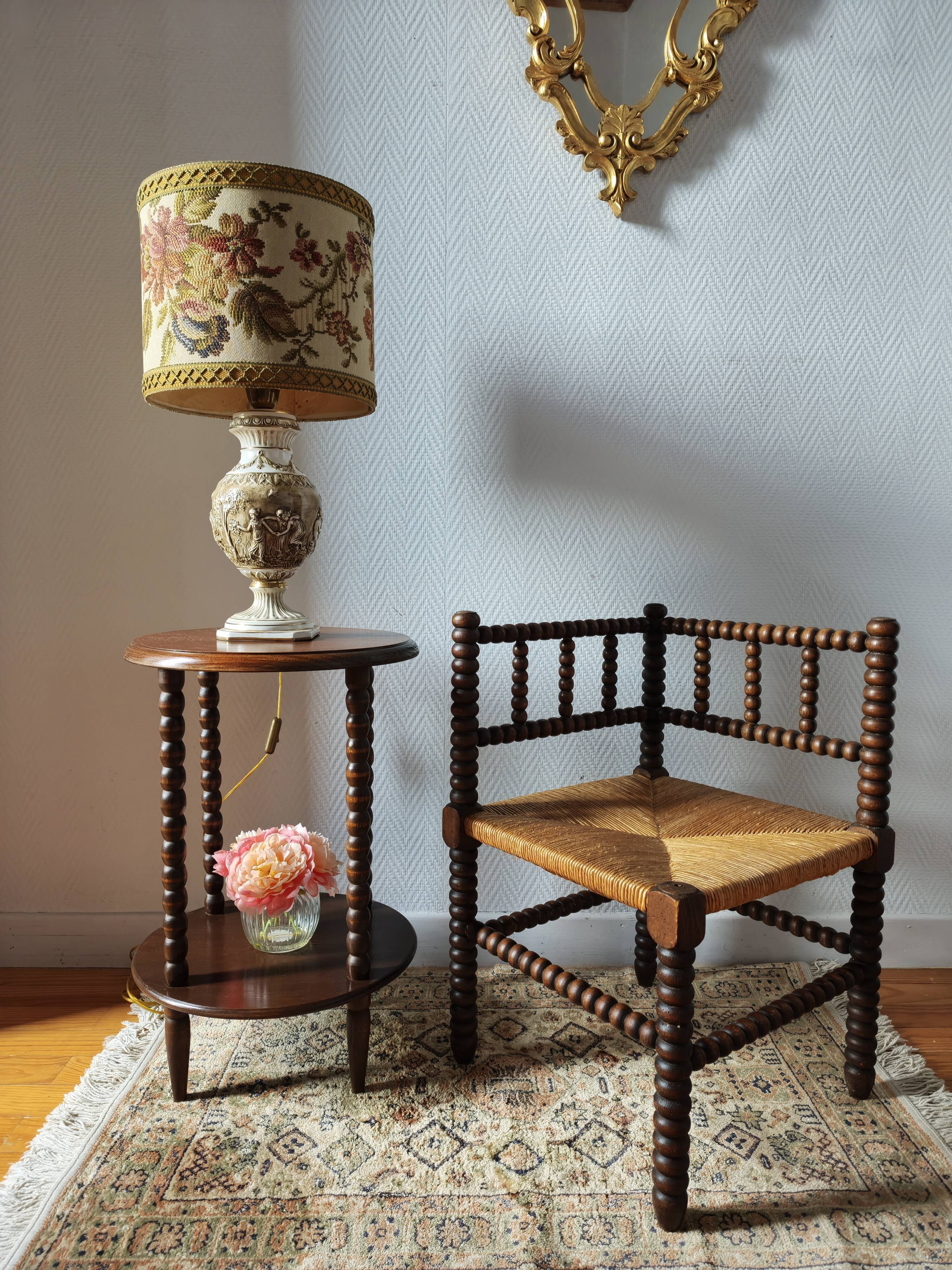 Old wooden turned spindle fireside chair with a straw seat.