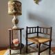 Old wooden turned spindle fireside chair with a straw seat.