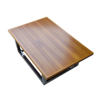 A convertable coffee table with chrome feet