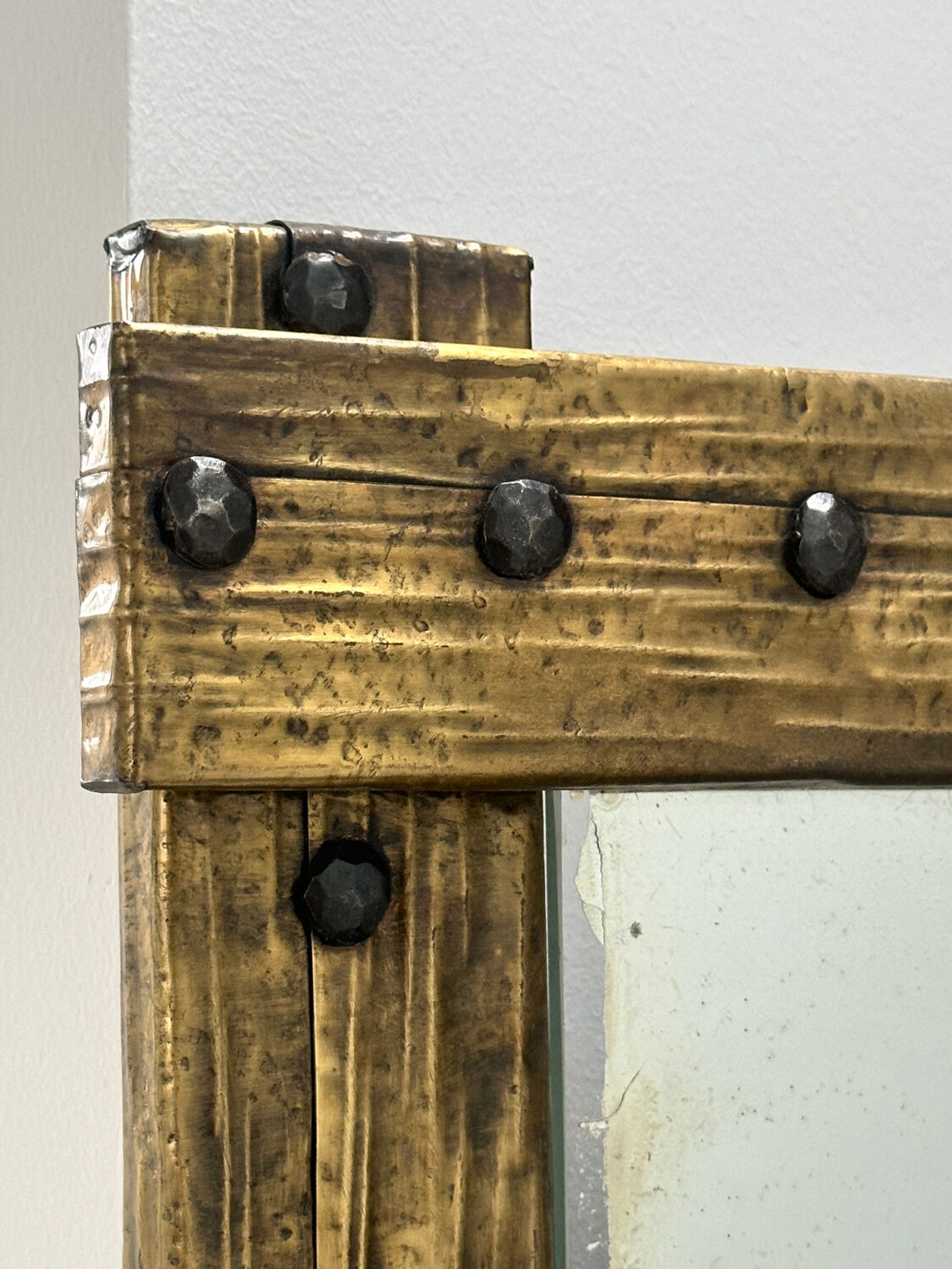 Brutalist mirror with a hammered copper and brass frame.