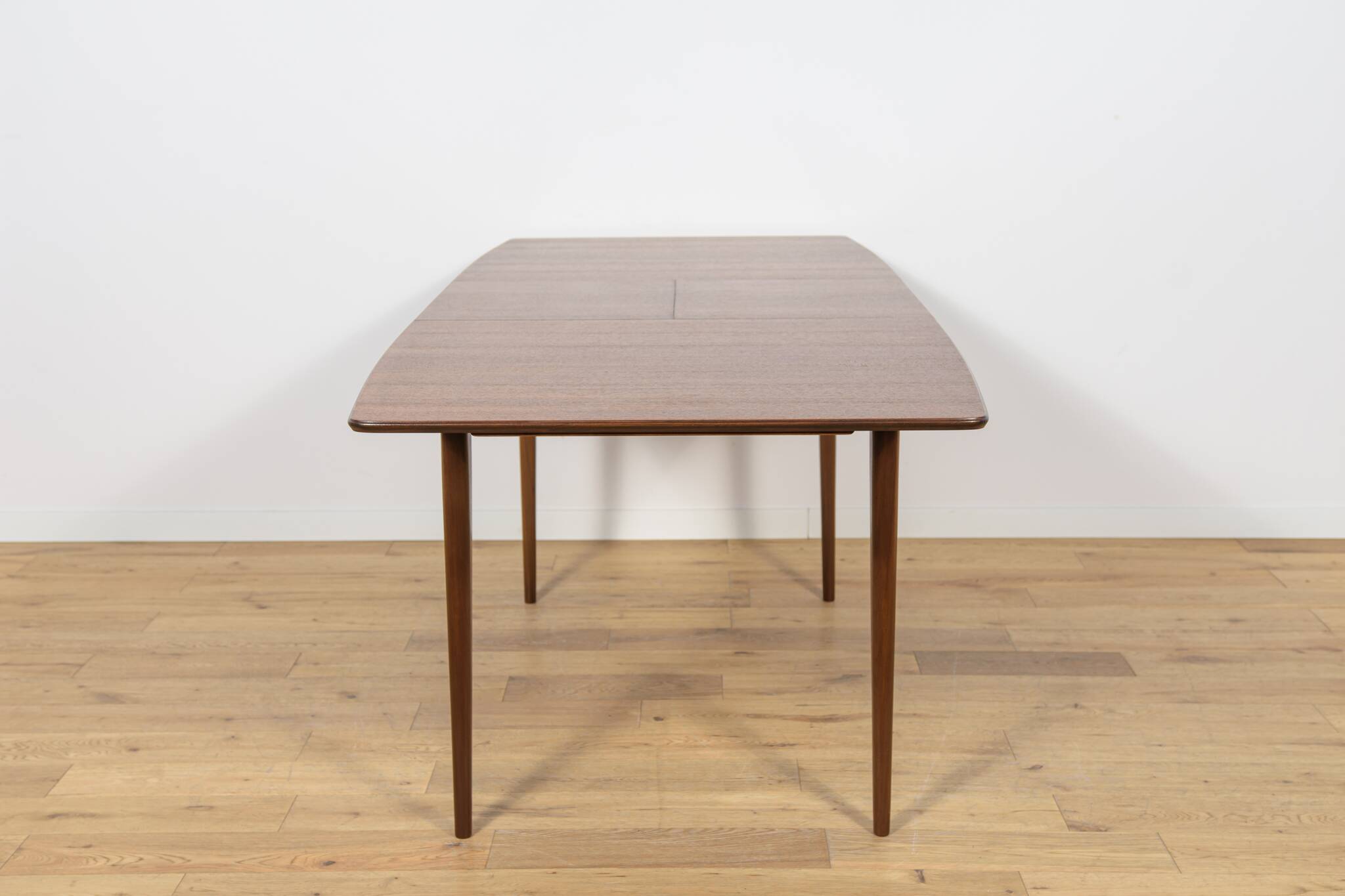 Extendable teak dining table in Mid-Century style from McIntosh, UK.